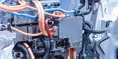 Chassis of the electric car with powertrain and power connections closeup.